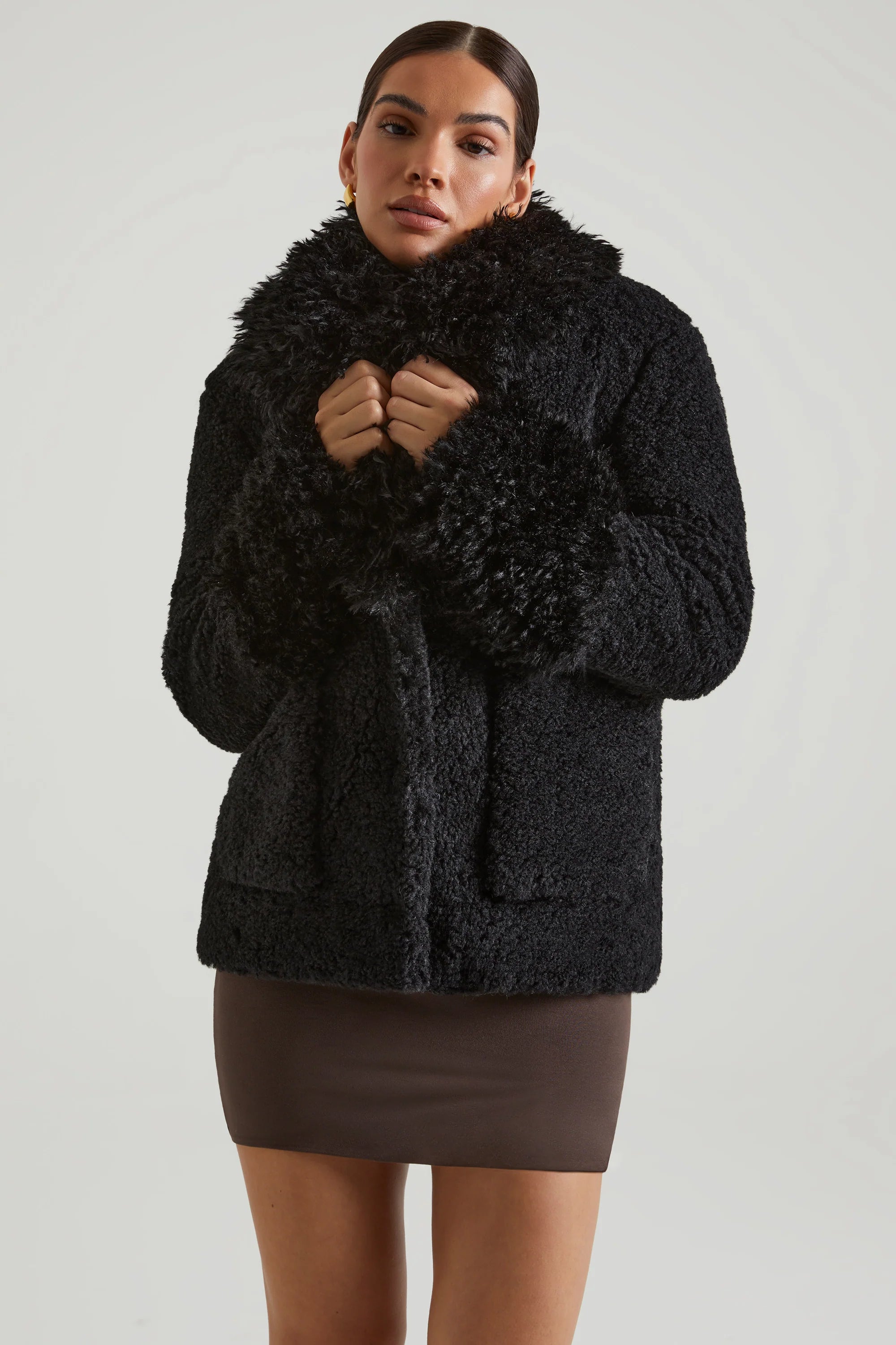 Cappotto in shearling con ampie tasche frontali in nero